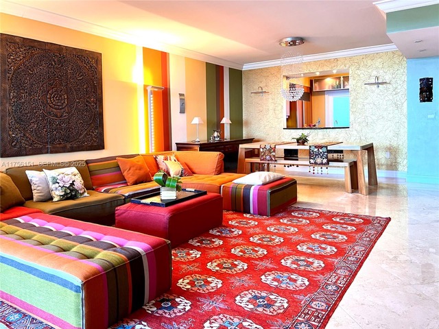 Colorful living room of Unit 8A at The Palms with red rug
