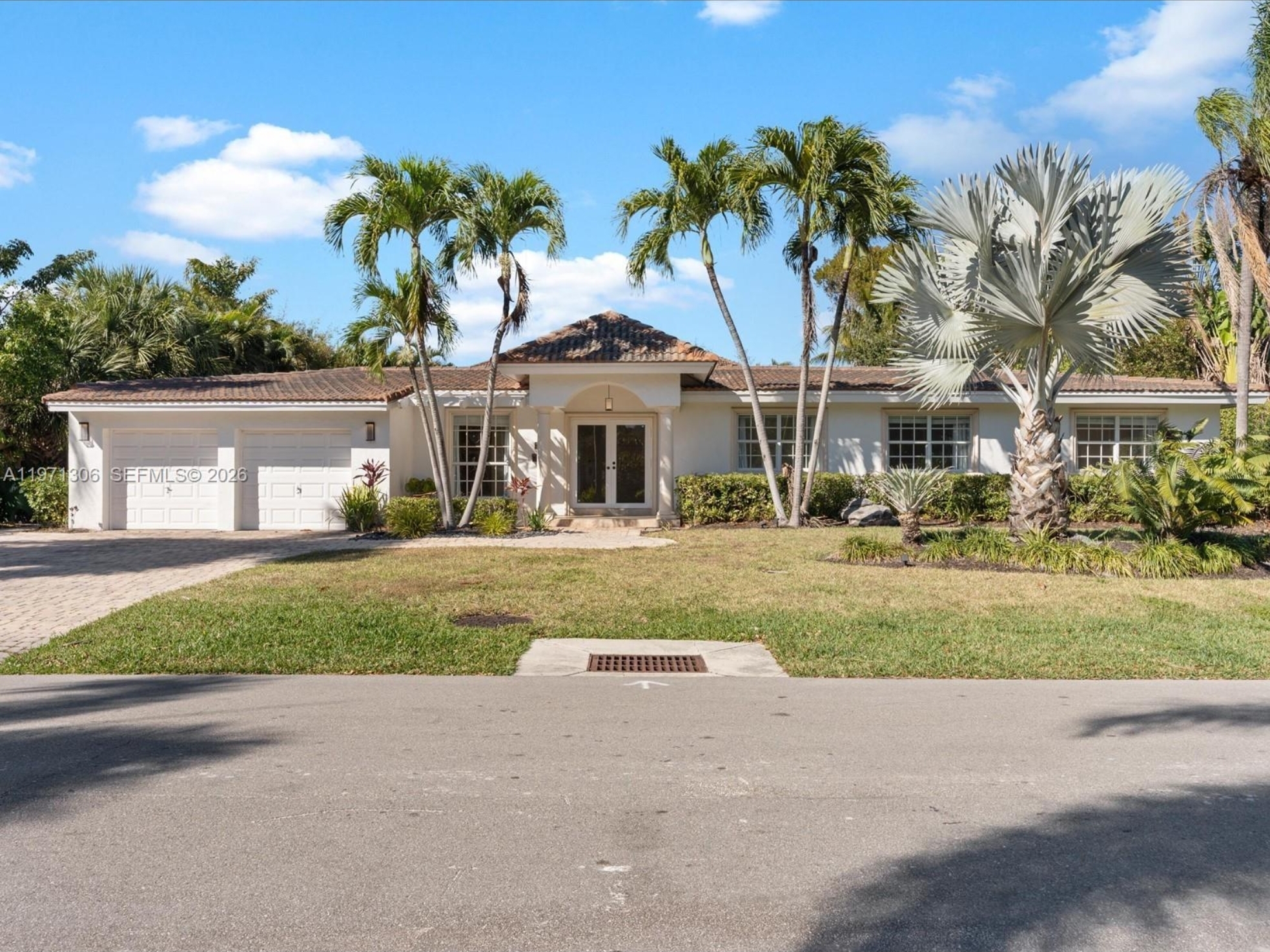 Single family home at 2833 NE 22nd St with palm trees